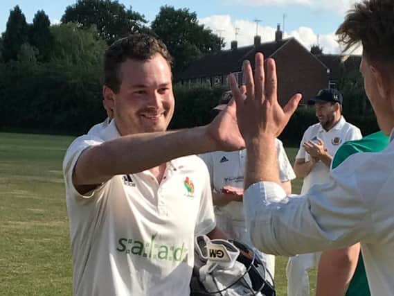 High fives for David Foster as he leaves the field at Acomb having guided Harrogate CC to victory with an unbeaten half-century