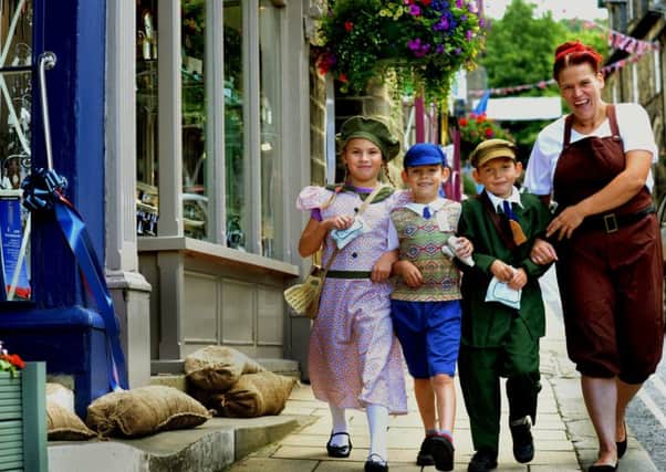Jo Mayven with her children (left to right) Amy, nine, Jim, six, and Ryan Williams, seven, dressed in period clothing on the high street. PIC: Gary Longbottom