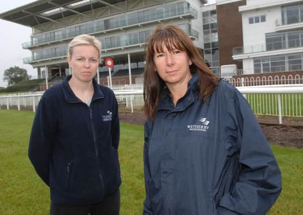 NAWN 1708082AM1 Wetherby racecourse dog mess. Maddy Clarke and Michelle Campbell of Wetherby of wetherby Racecourse.  (1708082AM1)