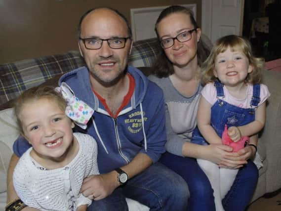 Mark Smith with his wife Caroline and daughters Emily (6) and Ellie (2). (1709051AM1)