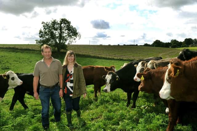 Richard and  Sue Thompson with some of their organic cattle. Picture by Gary Longbottom.