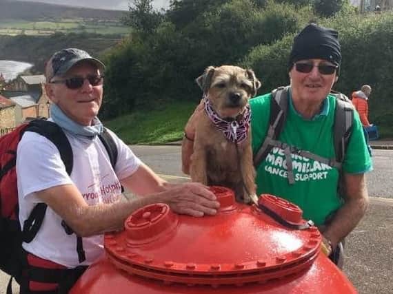 Finished! Leroy the terrier pictured at the end of his epic charity walk at Robn Hood's Bay with Ian Walker. (S)