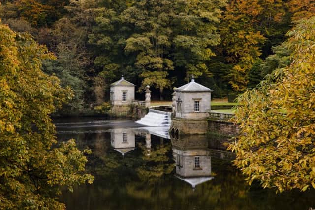 View of The Cascade (first started 1716-1730) into the Lake, showing rusticated columns and pavilions on the dam, in the garden at Studley Royal, North Yorkshire.