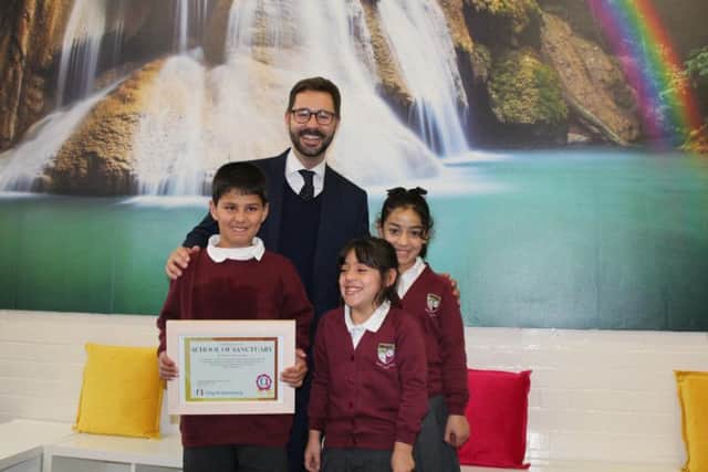 Grove Road Community Primary School headteacher Chris Parkhouse with the School of Sanctuary certificate presented to the school and pupils last year.