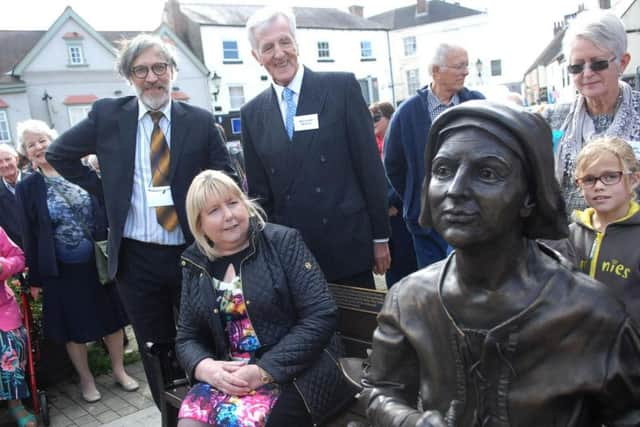 Angela James admires the statue of Mother Shipton with the sculpture Chris Kelly and Mike Owen. (1709301AM3)