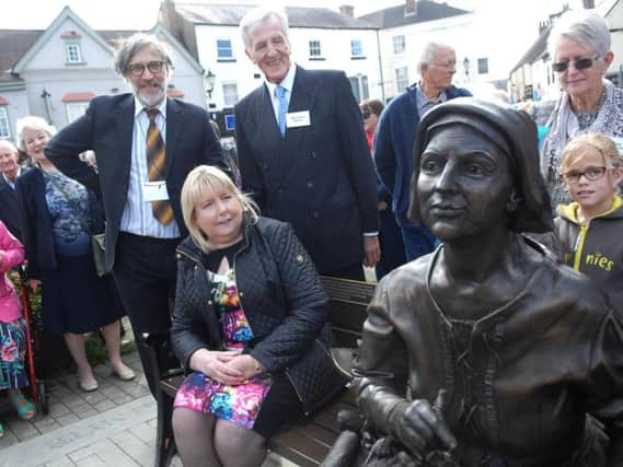 Angela James admires the statue of Mother Shipton with the sculpture Chris Kelly and Mike Owen. (1709301AM3)