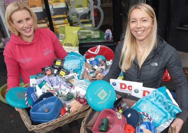 Kimberley Grundy of Pooches Galore and  Michaela Stothard of Posh Paws with the prize hampers. Picture: Adrian Murray