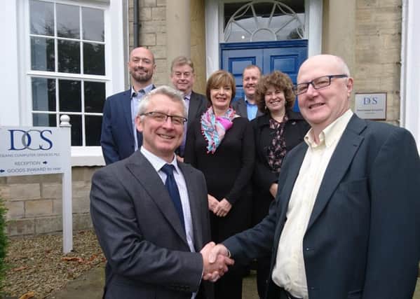 DCS managing director Patrick Clayton (left) and Leckhampton director Steve Robson celebrate the merger of their companies with (l to r) DCS sales director Barry Rankin, Leckhampton director Richard Foulds, DCS marketing director Suzie Cowling, DCS technical director Chris Lord, and DCS support director Sandra Marshall. (S)