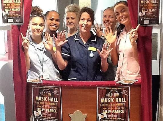 The staff of Jervaux Ward in Harrogate Hospital in the Old Time Music Hall  box office in the hospital's foyer.