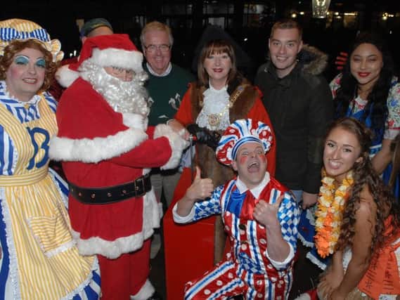 The Mayor of the Borough of Harrogate, Coun Anne Jones, Father Christmas and  the Chairman of Harrogate at Christmas, Coun John Fox, switch on the Harrogate Christmas lights with help from the cast of Harrogate Theatre's production of Beauty and the Beast and entertainers.(1711162AM19).