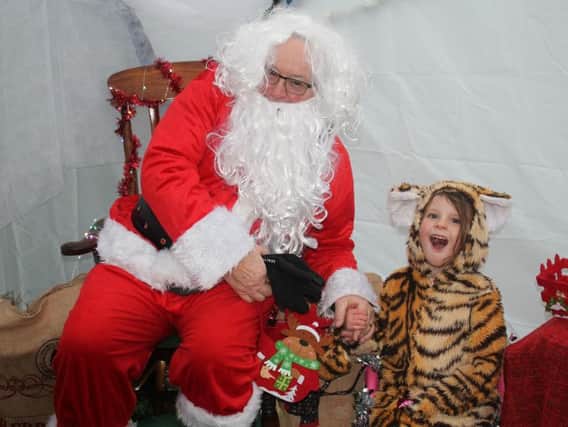 Kids give Santa their wishes at special Rotary grotto