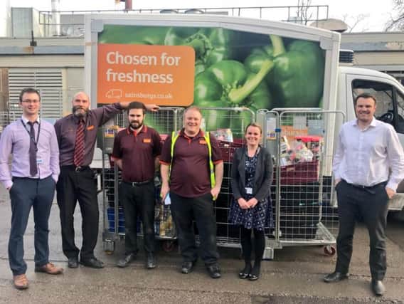 Staff from Sainsbury's and HDFT gather as the snacks get dropped off at the hospital. Picture: HDFT