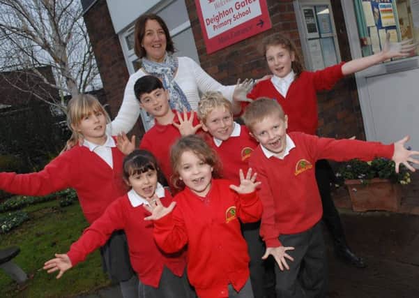 NAWN 1801093AM A delighted Headteacher Claire Harrison and youngsters fron Deighton Gates Primary School celebrate their good Ofsted report.