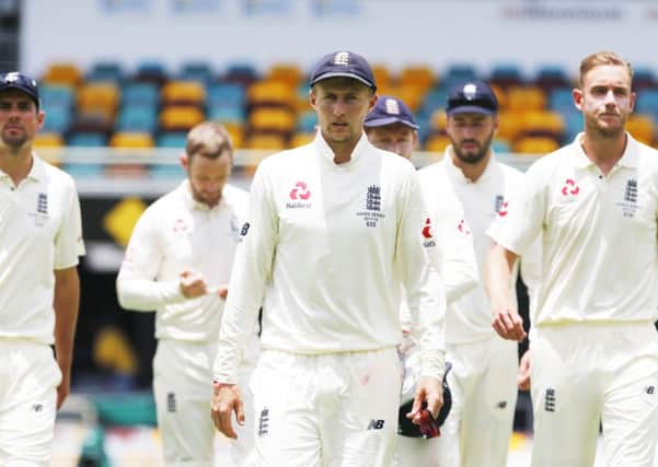GOING DOWN: England's Joe Root leads his players off the pitch after defeat in the opening Ashes Test match at The Gabba in Brisbane. Picture: Jason O'Brien/PA
