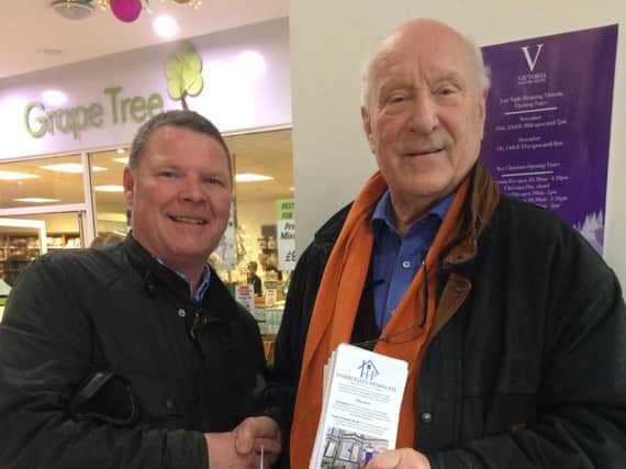 Chair of Trustees John Harris (right) with one of the volunteers at the Victoria Centre collection