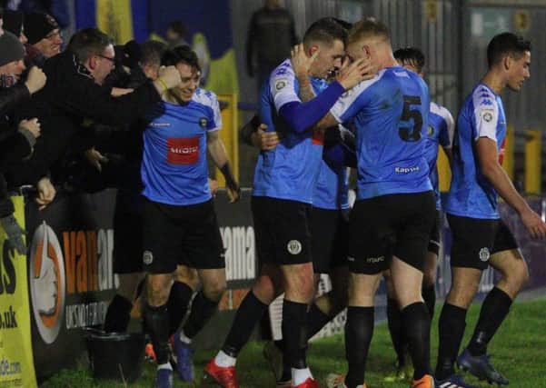 Harrogate Town players celebrate with their travelling supporters after Joe Leesley, centre, bagged a late equaliser at St Albans. Picture: Town Pix
