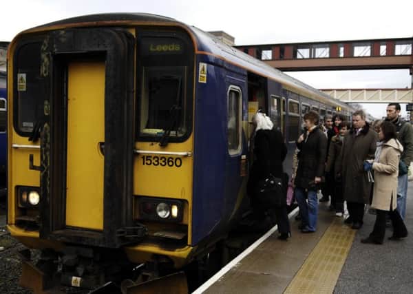 Commuters wait to board the train to Leeds at Harrogate Train Station.