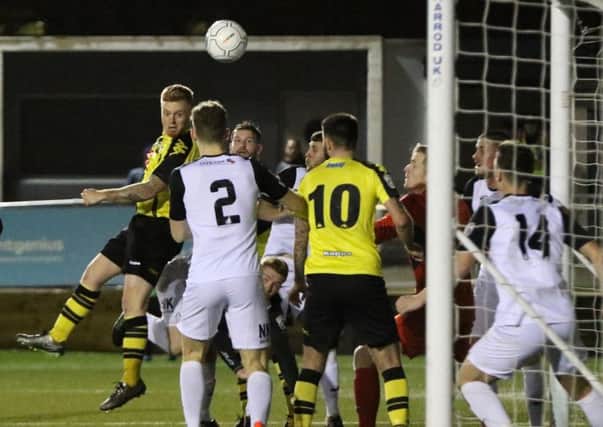 Terry Kennedy heads home Harrogate Town's fourth of the night against Stockport County. Picture: Town Pix