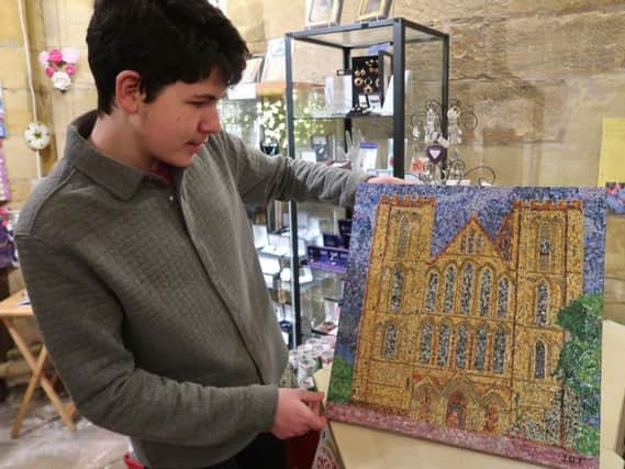 Upcycling artist James Thomas, 16, at his own exhibition at Ripon Cathedral.