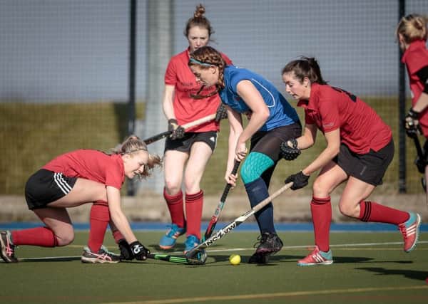 Harrogate Ladies 1s' Sarah Gibbins is closed down by a trio of Pendle Forest players. Picture: Caught Light Photography
