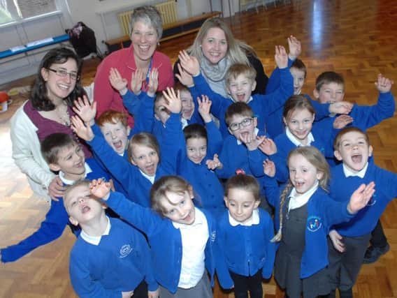 Teachers Bridget Taylor-Connor, Chloe Fletcher and  Deputy Head Teacher Claire Rowett, with some of the children celebrating the school's Ofsted report.  (1802272AM1).