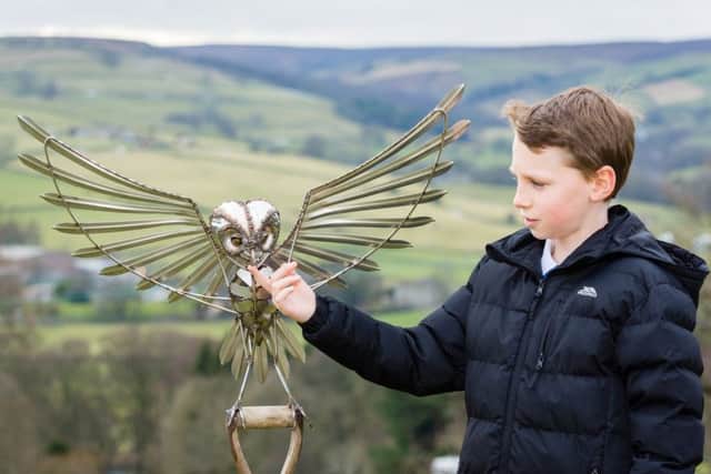 Pictured Will Whorley, 9, with owl sculpture by artist, Steve Blaylock. Photo credit: Mike Whorley Photography (s).