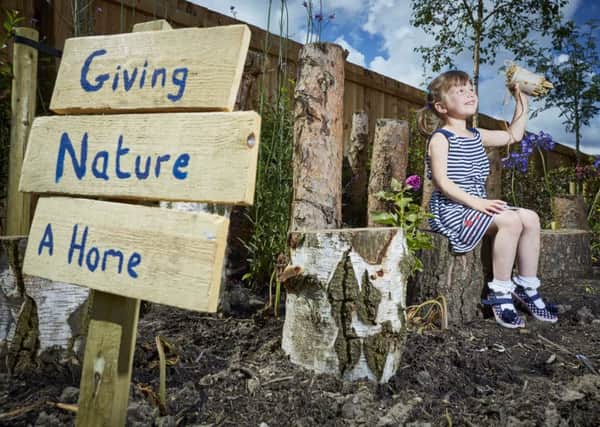 DWH David Wilson Homes new show home has a special garden designed for insects and wild animals. Pictured at the Cromwell Heights in Longridge, Preston site Lyra Coolican aged 4 building an insect home