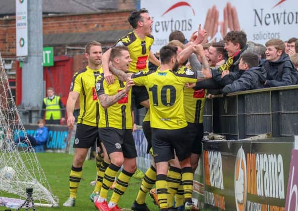 Harrogate Town players celebrate their second goal against York City in front of their travelling support. Picture: Town Pix