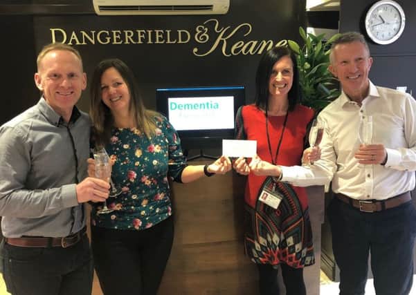 Shaun Somerville-Frost (l) and Gerri Keane (r) of Dangerfield & Keane hand over Â£1,000 to Nettie Newell and Fiona Andrews of Dementia Forward. (S)