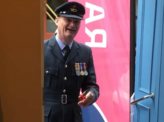 Squadron leader Geoff Dickson, Commanding Officer at Menwith Hill, cuts the ribbon.