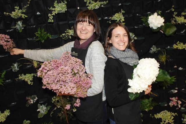 Helen James and her daughter Laura of Helen James Flowers work on their display