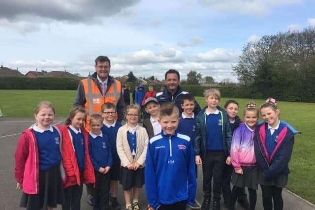 Harrison with dad, Darren, Headteacher, Andrew Symonds and Harrison's classmates from Richard Taylor.