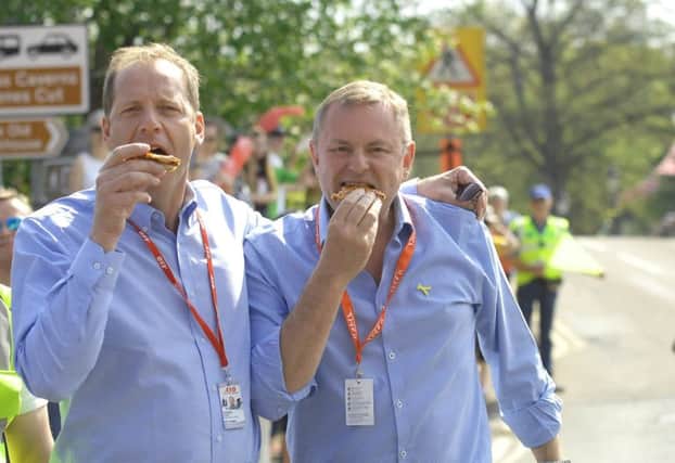 Christian Prudhomme and The Chief Executive of Welcome to Yorkshre  Sir Gary Verity tuck into pizza as they have a break in Pateley Bridge. Picture by  Adrian Murray.  (1805061AM28)