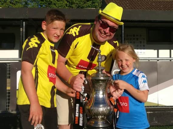 Jordan Ford celebrating Harrogate Town's promotion with his children.